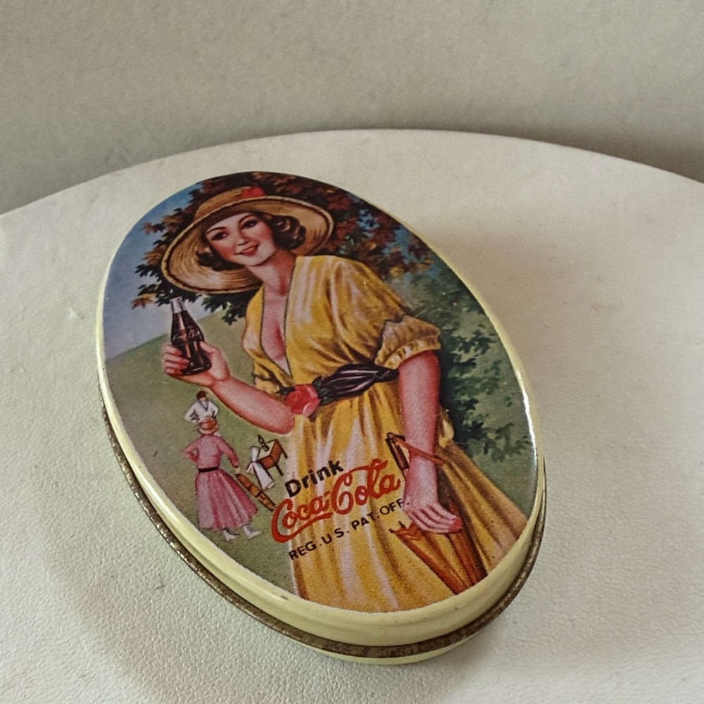 Coca-Cola Oval Tin with Yellow Dress and Red Logo